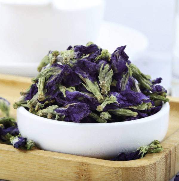 Dried butterfly pea flowers on a white plate – natural herbal ingredients for blue tea
