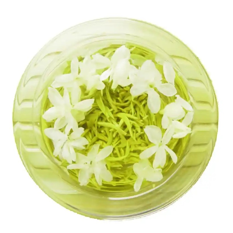 Glass cup of jasmine tea with a tea infuser, surrounded by blooming jasmine flowers on a rustic wooden table – warm and cozy herbal tea concept