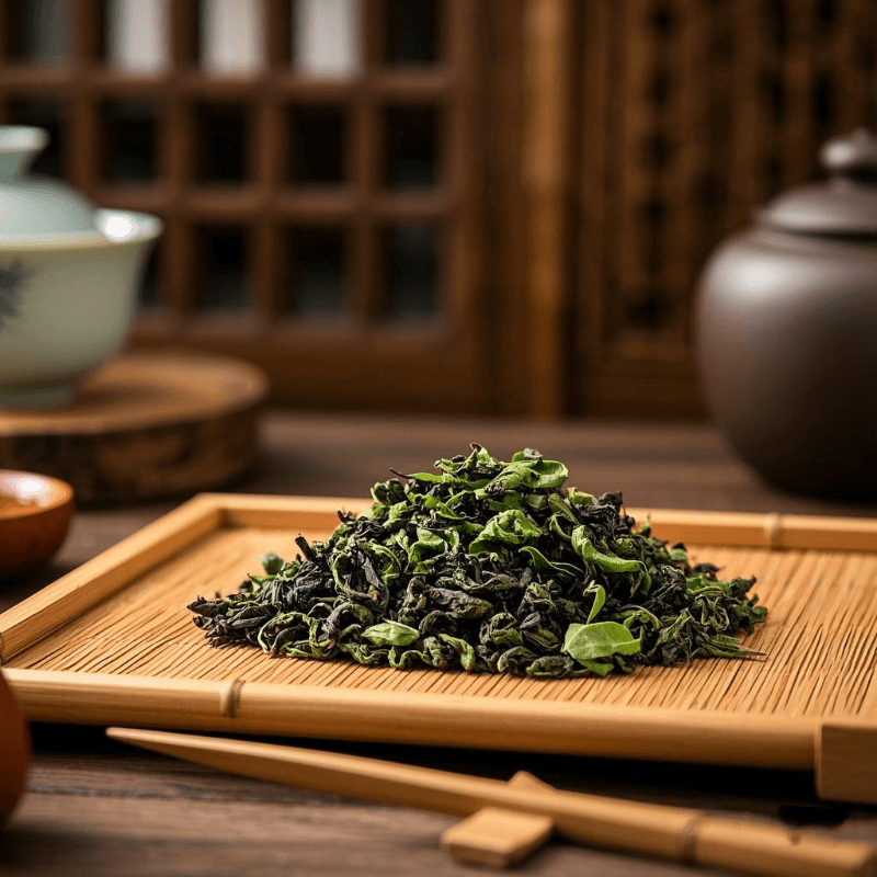 Close-up of premium loose leaf oolong tea on a bamboo tea tray, showing curled and glossy tea leaves under warm lighting, highlighting the natural texture and artisanal quality of this semi-fermented tea