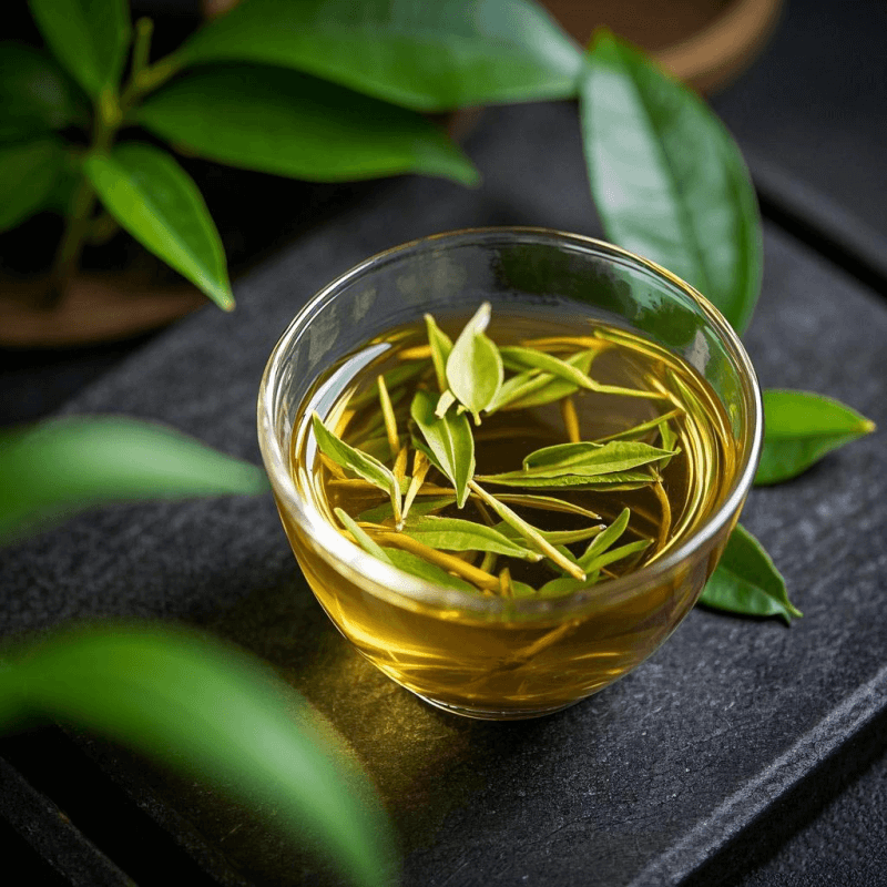Freshly brewed Milk Oolong Tea in a glass teapot, golden liquor with unfurled Jin Xuan leaves, showing the benefits of proper brewing.